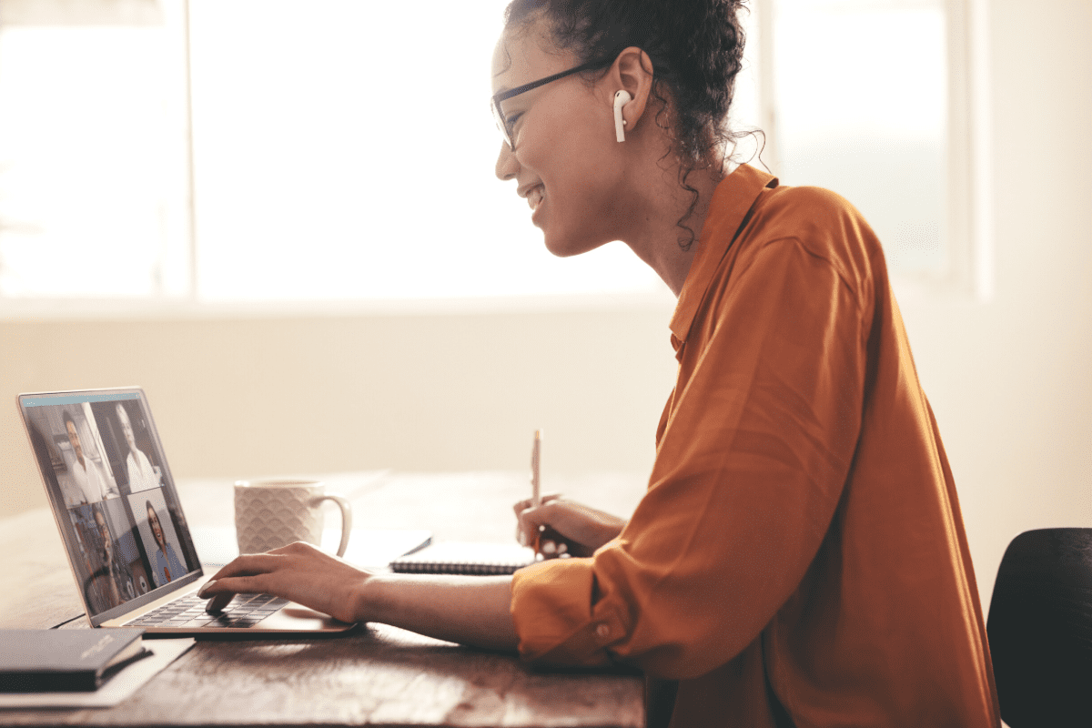 Woman Working on a Computer doing an online meeting with her team