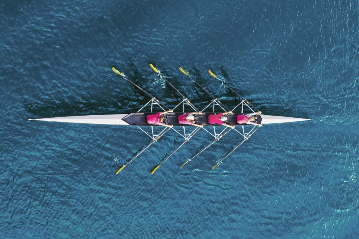 A rowing team shot from above praticing rowing as a team